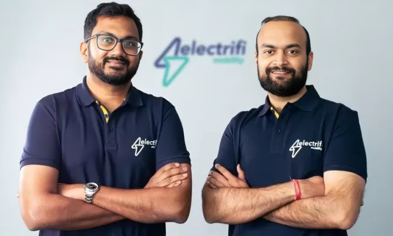 Two men standing with their arms crossedDescription automatically generated